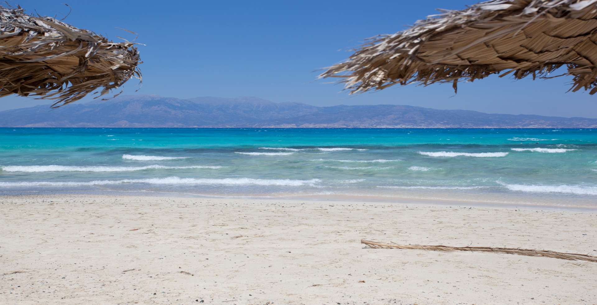 Sandy-beach-gentle-waves-view-to-the-coastline-of-Crete